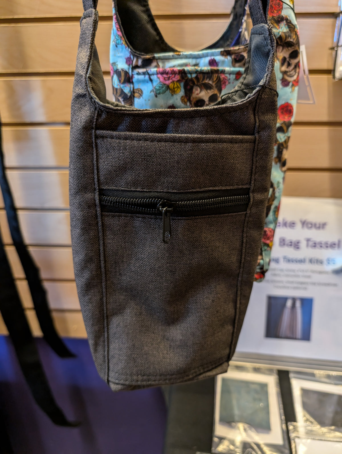 Gray handmade water bottle carrier with adjustable crossbody strap and zip pocket